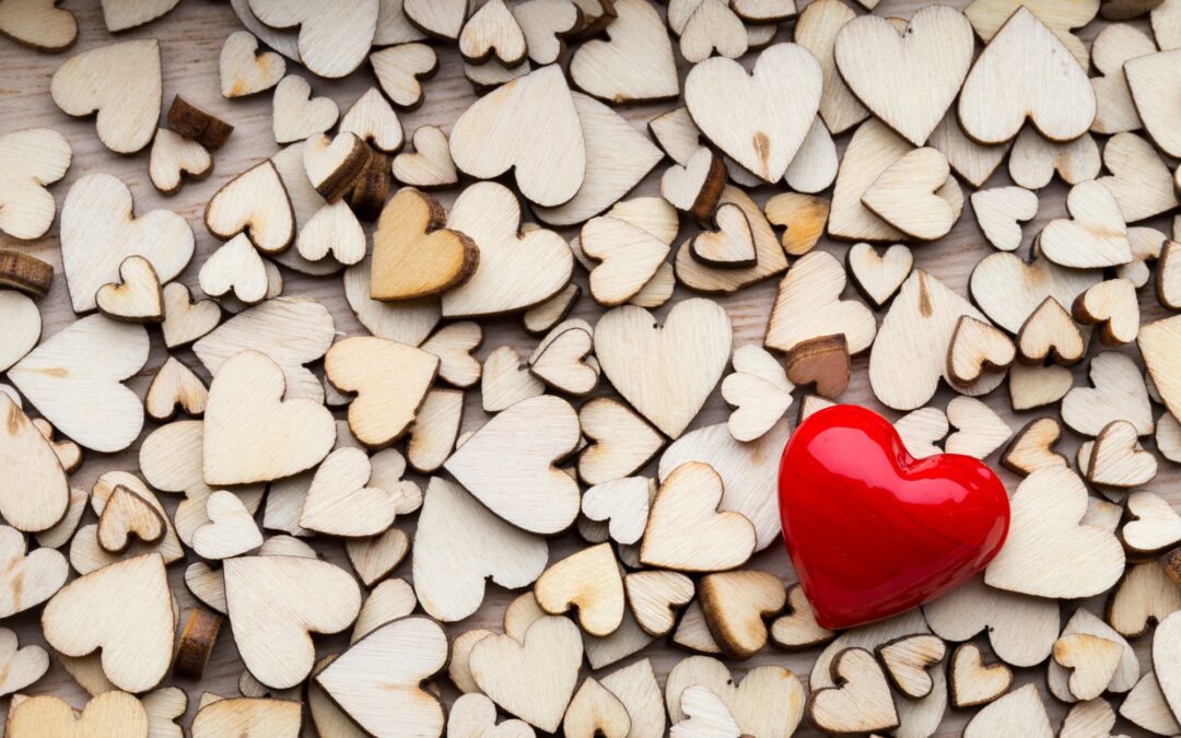 Wooden hearts, one red heart on the heart background.
